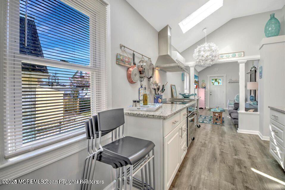 604 1/2 12th Avenue, Unit BACK HOUSE Belmar, NJ 07719 - Photo 11 of 19 a bathroom with a sink a mirror and a shower