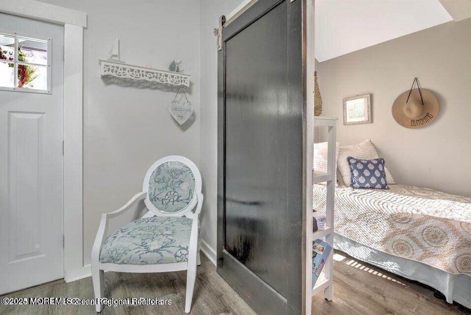 604 1/2 12th Avenue, Unit BACK HOUSE Belmar, NJ 07719 - Photo 12 of 19 a bedroom with a bed and a table in it