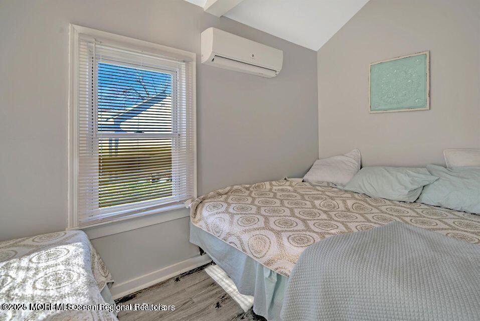 604 1/2 12th Avenue, Unit BACK HOUSE Belmar, NJ 07719 - Photo 13 of 19 a bedroom with a bed and a window
