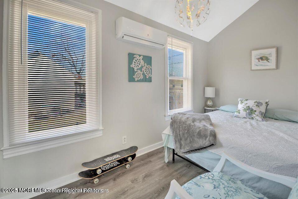 604 1/2 12th Avenue, Unit BACK HOUSE Belmar, NJ 07719 - Photo 16 of 19 a bedroom with a bed and a window