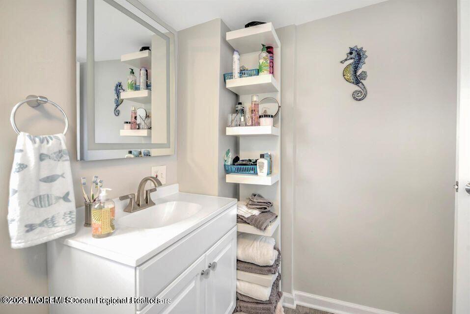 604 1/2 12th Avenue, Unit BACK HOUSE Belmar, NJ 07719 - Photo 17 of 19 a bathroom with a sink and a mirror