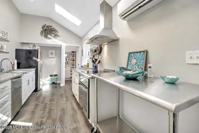 a kitchen with stainless steel appliances a sink stove and cabinets