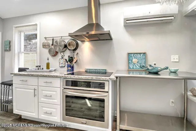 a kitchen with stainless steel appliances granite countertop a stove and a sink
