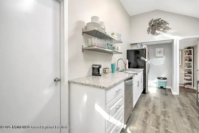 a kitchen with stainless steel appliances granite countertop a sink and cabinets
