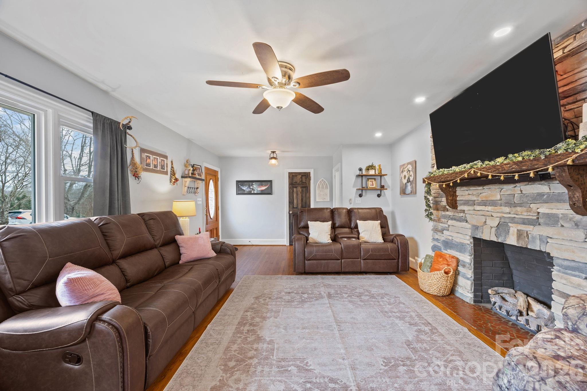 275 Tanner Street Rutherfordton, NC 28139 - Photo 18 of 44 a living room with furniture a flat screen tv and a fireplace