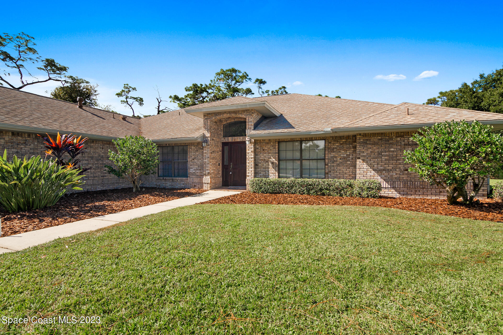 3928 Sparrow Hawk Road Melbourne, FL 32934 - Photo 3 of 39 front view of a house with a yard