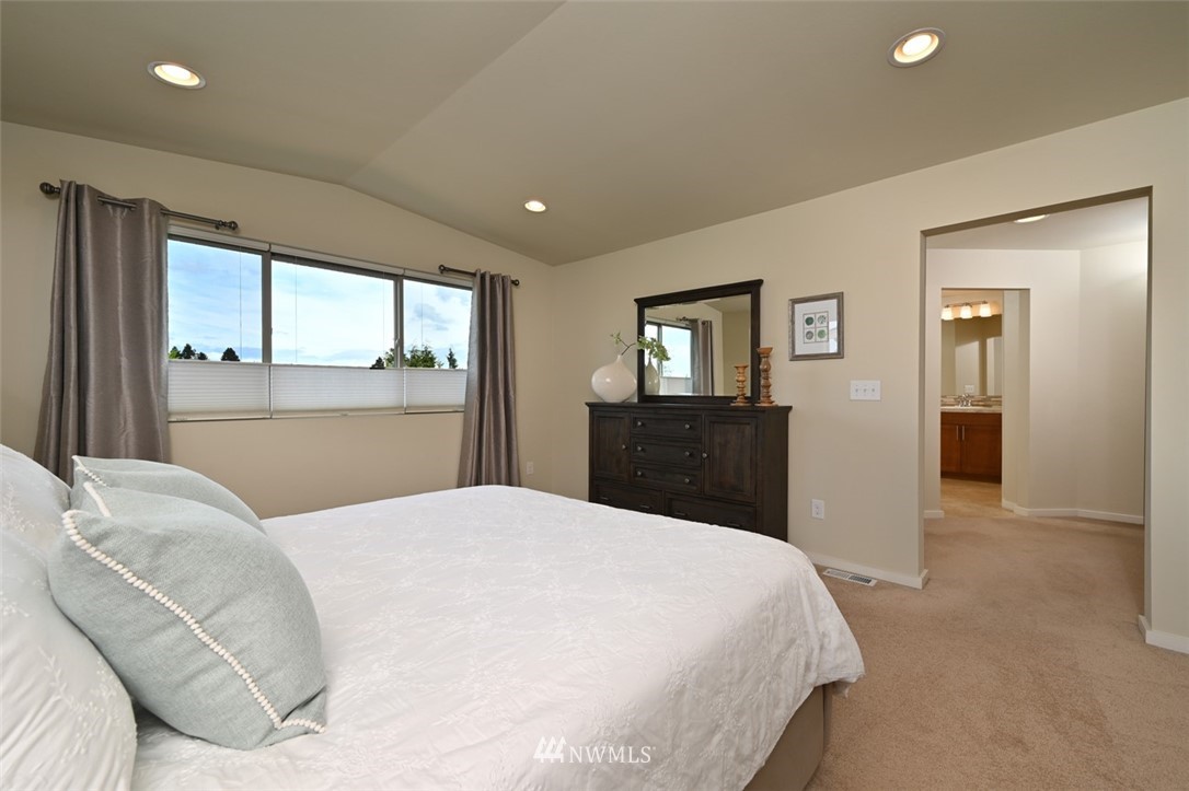 1500 South 28th Street Renton, WA 98055 - Photo 16 of 29 a bedroom with a large bed and dresser with mirror