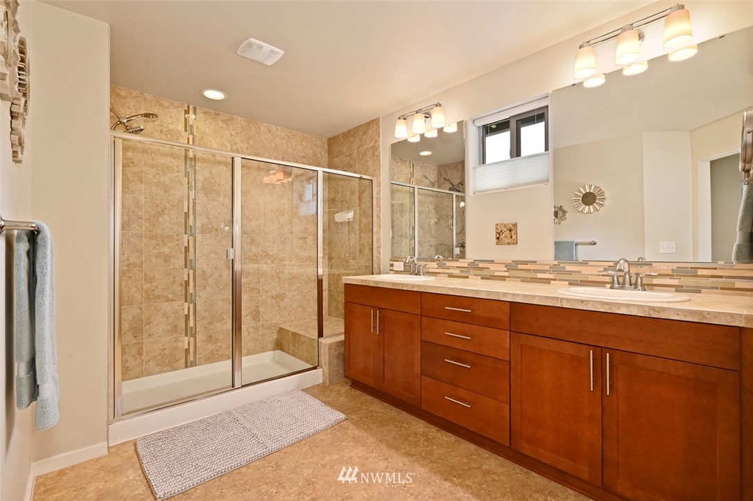 1500 South 28th Street Renton, WA 98055 - Photo 18 of 29 a bathroom with a granite countertop sink a mirror and a shower