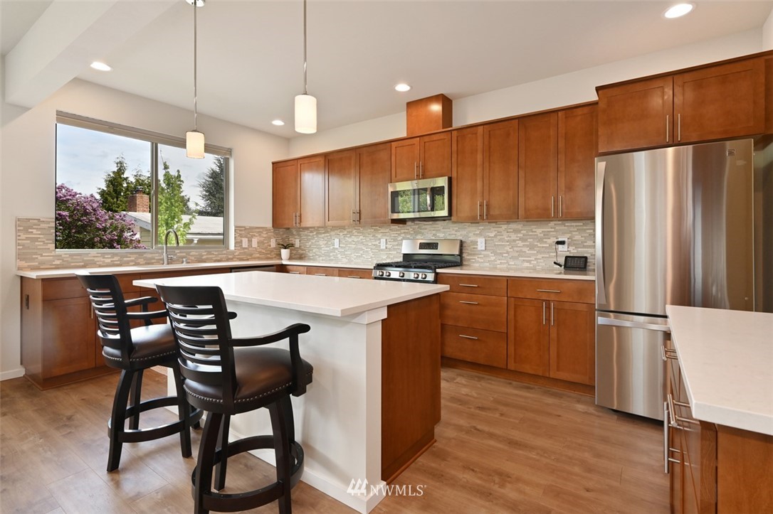 1500 South 28th Street Renton, WA 98055 - Photo 7 of 29 a kitchen with kitchen island a white cabinets and refrigerator