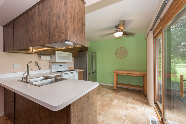 770 Chandler Road Gurnee, IL 60031 - Photo 8 of 31 a kitchen with a sink cabinets and wooden floor