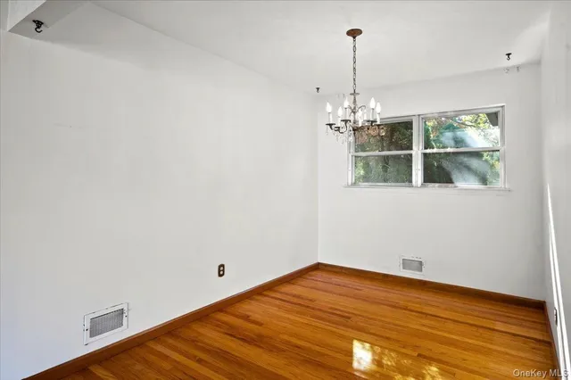 a view of a room with wooden floor and windows