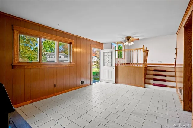 a view of a bedroom with furniture and window