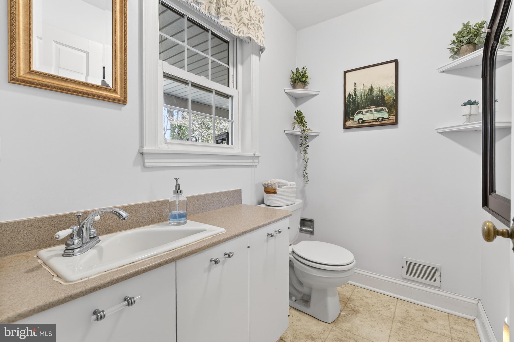 2315 Edgewood Road Harrisburg, PA 17104 - Photo 19 of 41 a bathroom with a granite countertop sink toilet and a mirror