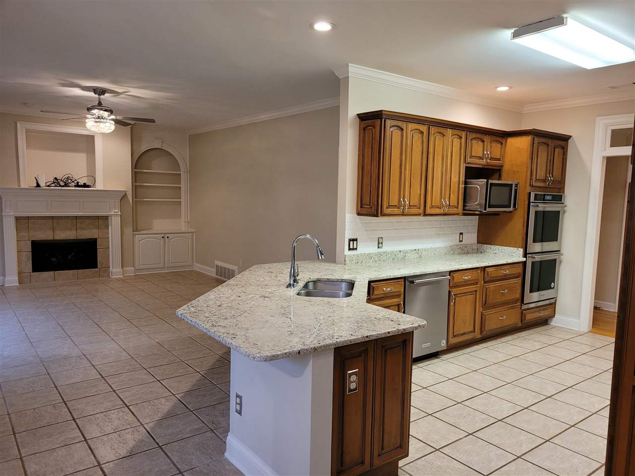 536 Estanaula Road Collierville, TN 38017 - Photo 11 of 25 a kitchen with a sink refrigerator and cabinets