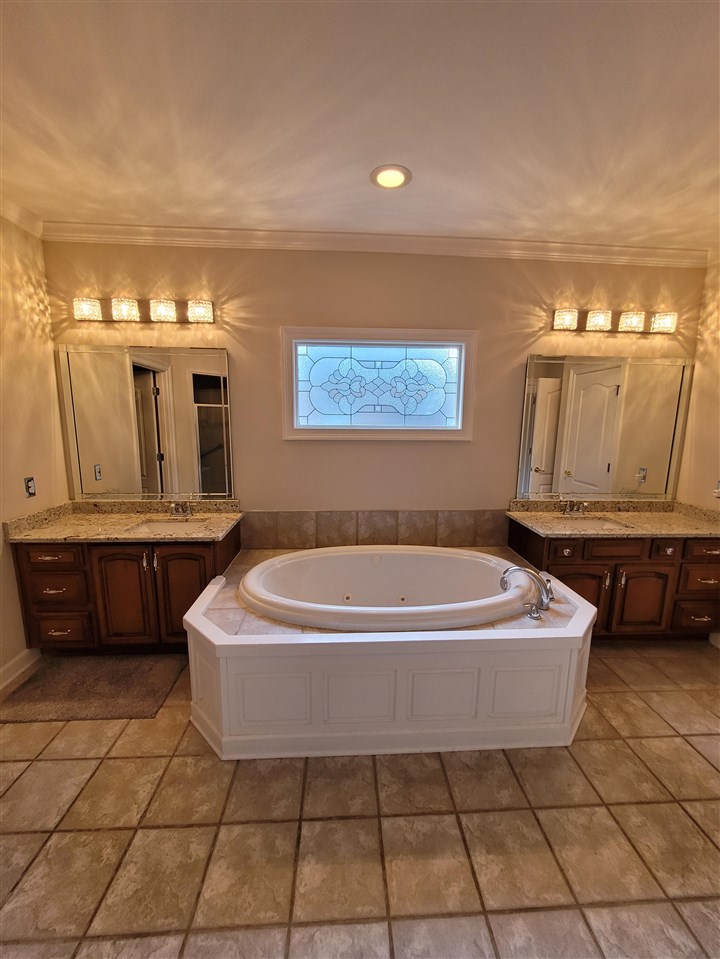 536 Estanaula Road Collierville, TN 38017 - Photo 15 of 25 a bath tub sitting in a bathroom next to a sink