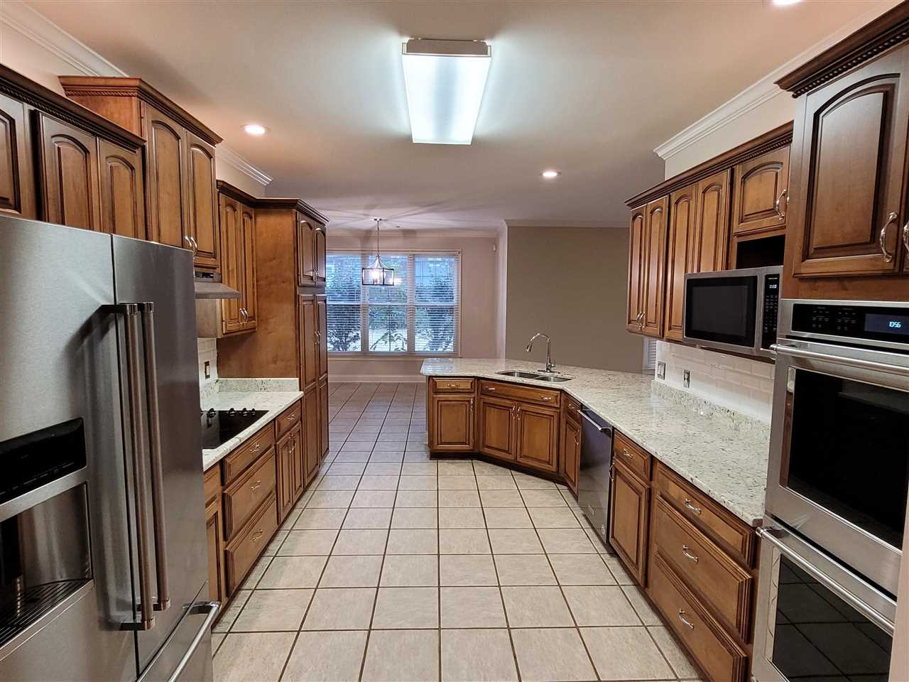 536 Estanaula Road Collierville, TN 38017 - Photo 8 of 25 a kitchen with stainless steel appliances a refrigerator a sink and stove