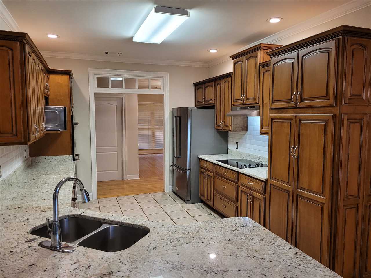 536 Estanaula Road Collierville, TN 38017 - Photo 9 of 25 a kitchen with stainless steel appliances granite countertop a refrigerator a sink and wooden cabinets