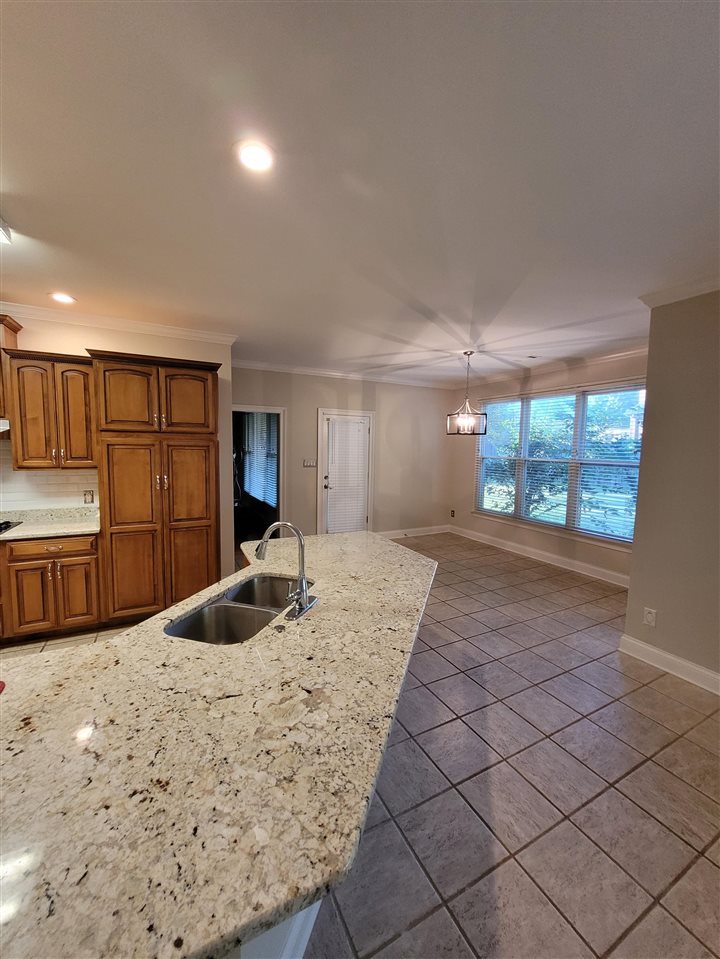 536 Estanaula Road Collierville, TN 38017 - Photo 10 of 25 a living room with stainless steel appliances kitchen island granite countertop a sink a stove and a large window