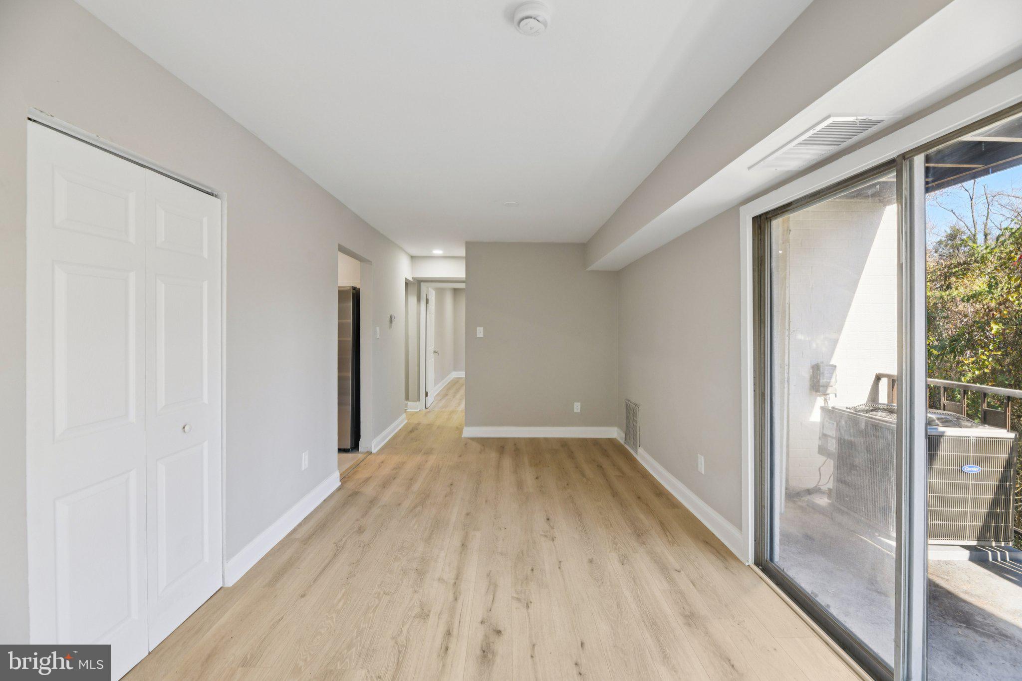3138 Brinkley Road, Unit 8102 Temple Hills, MD 20748 - Photo 12 of 27 a view of a hallway with wooden floor and glass door