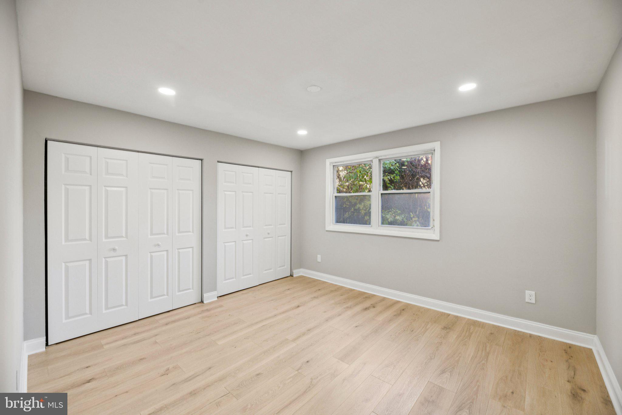3138 Brinkley Road, Unit 8102 Temple Hills, MD 20748 - Photo 13 of 27 a view of an empty room with wooden floor and a window