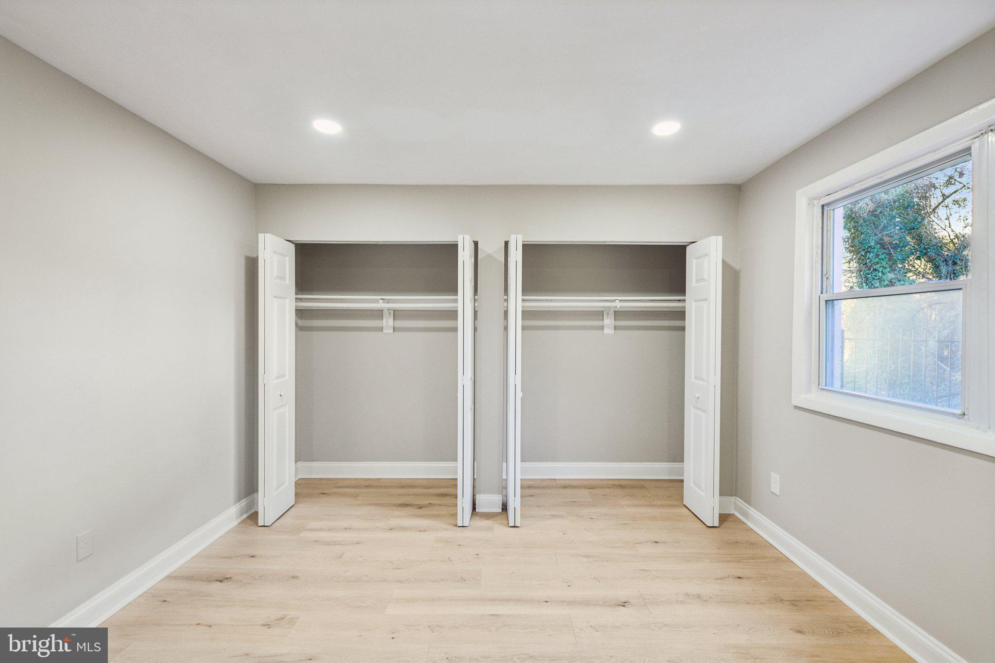 3138 Brinkley Road, Unit 8102 Temple Hills, MD 20748 - Photo 15 of 27 a view of an empty room with window and wooden floor