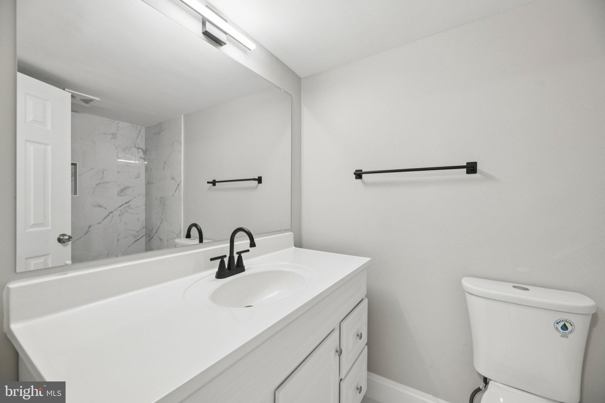 3138 Brinkley Road, Unit 8102 Temple Hills, MD 20748 - Photo 21 of 27 a bathroom with a sink and a mirror