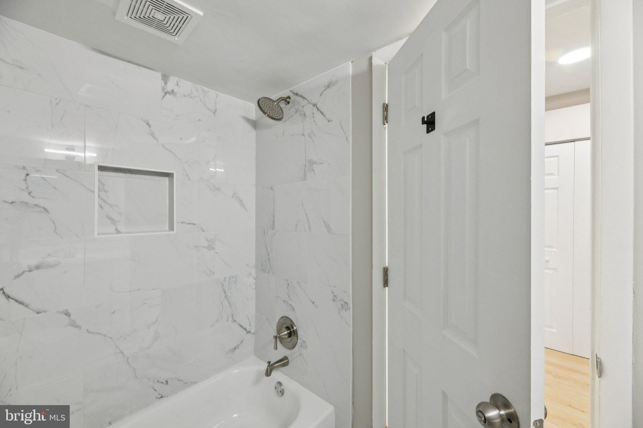 3138 Brinkley Road, Unit 8102 Temple Hills, MD 20748 - Photo 22 of 27 a bathroom with a bathtub and shower