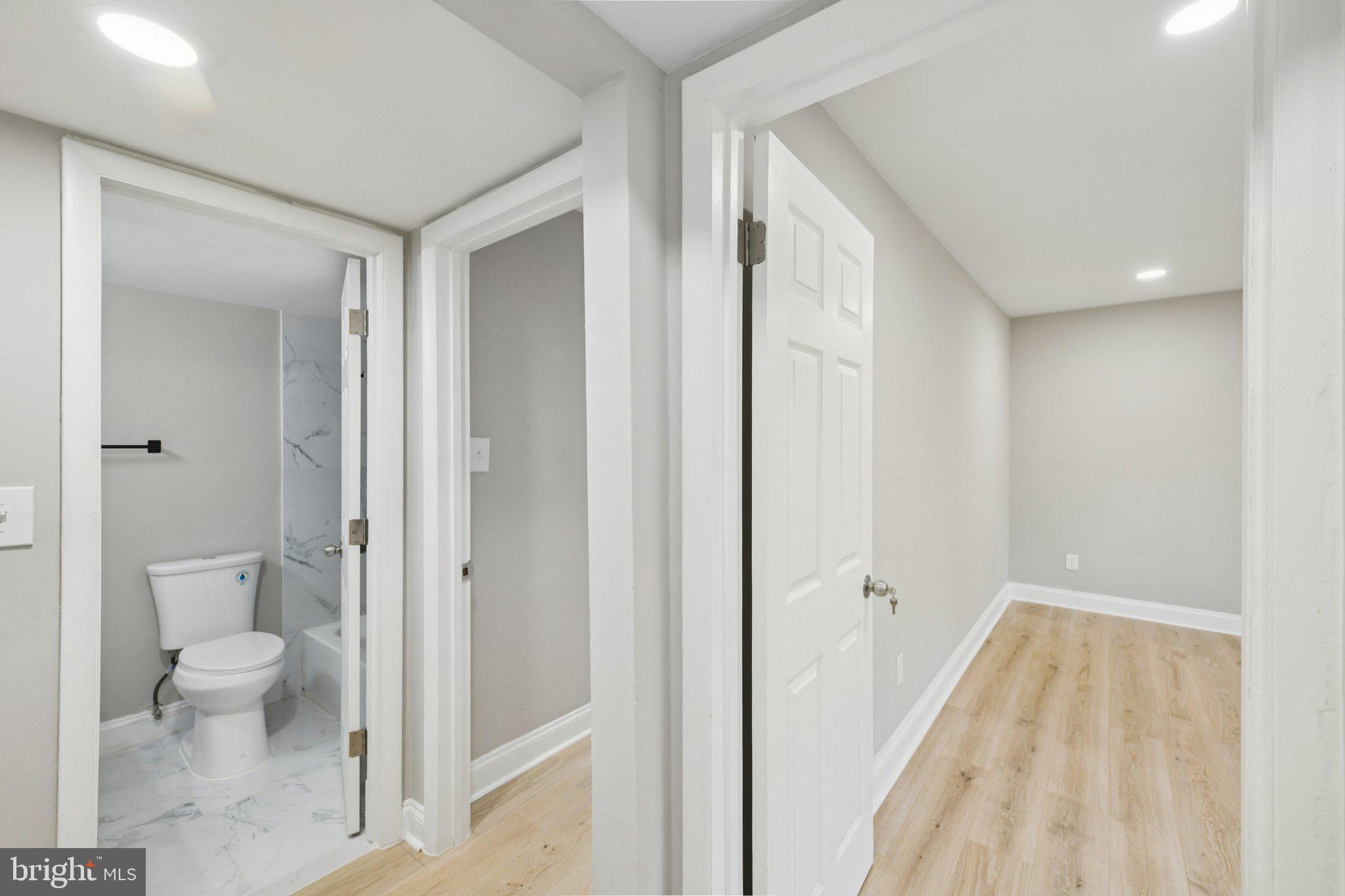 3138 Brinkley Road, Unit 8102 Temple Hills, MD 20748 - Photo 23 of 27 a bathroom with a granite countertop sink a toilet and shower