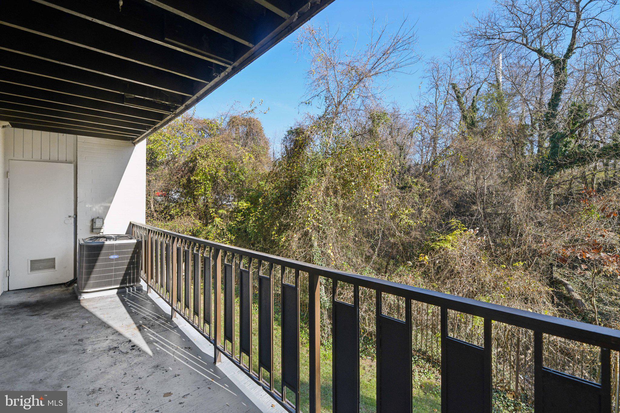 3138 Brinkley Road, Unit 8102 Temple Hills, MD 20748 - Photo 25 of 27 a view of a balcony with wooden floor and fence