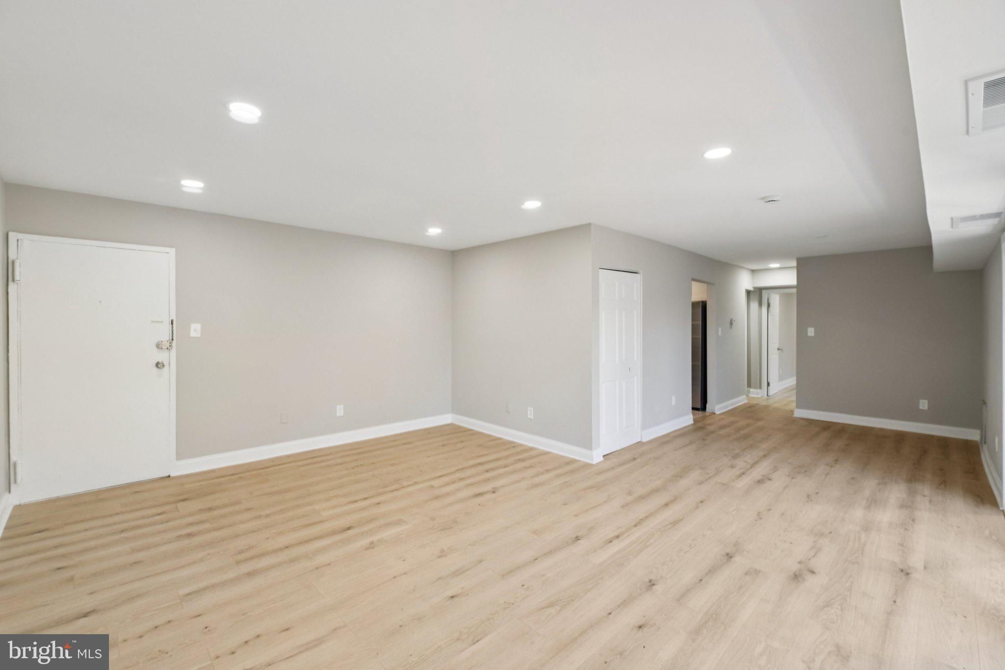 3138 Brinkley Road, Unit 8102 Temple Hills, MD 20748 - Photo 3 of 27 a view of an empty room with wooden floor