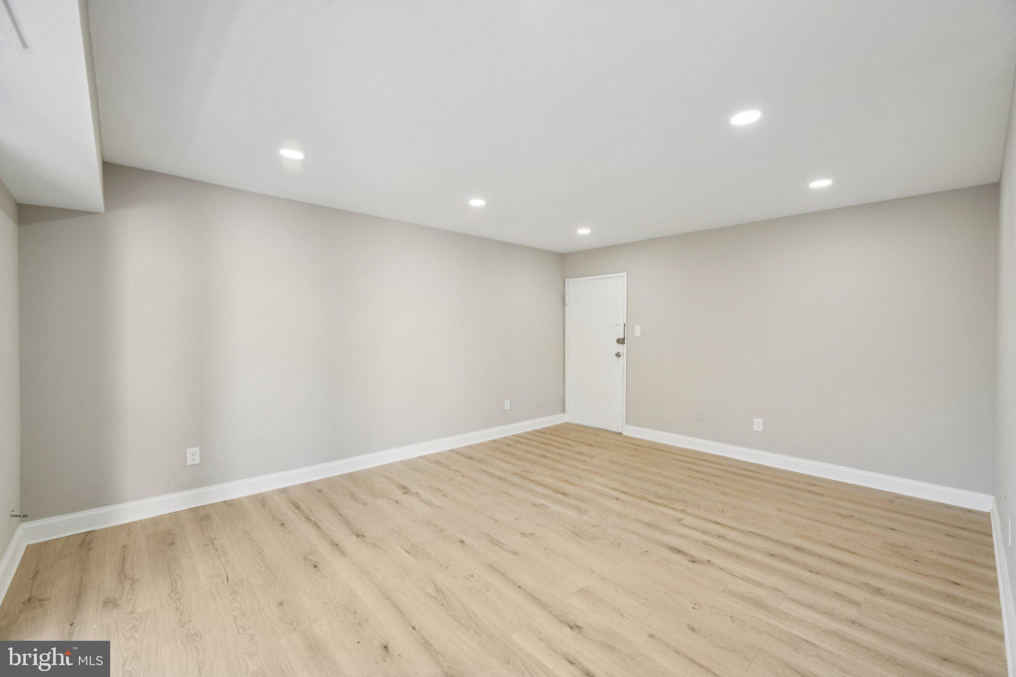 3138 Brinkley Road, Unit 8102 Temple Hills, MD 20748 - Photo 5 of 27 an empty room with wooden floor and white walls