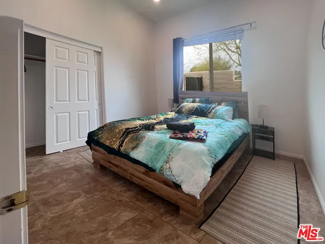 a bedroom with a bed and window