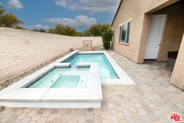 a view of a swimming pool with furniture