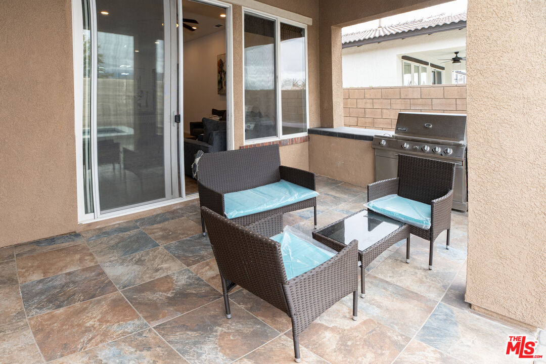 84226 Canzone Drive Indio, CA 92203 - Photo 20 of 23 a living room with fireplace furniture and a table