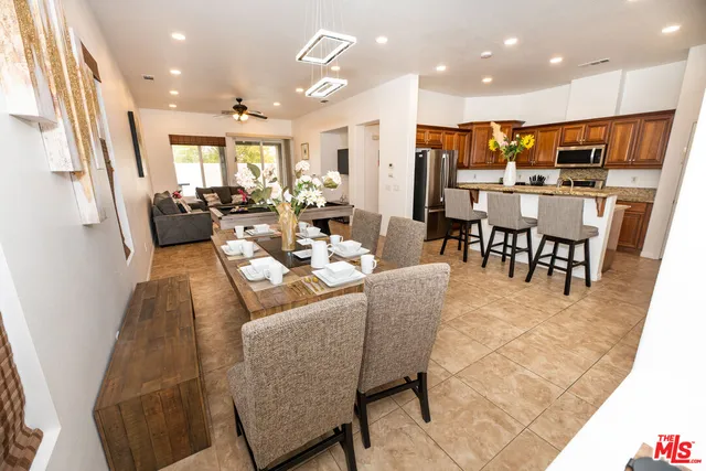 a living room with lots of furniture and kitchen view
