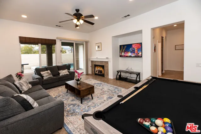 a living room with furniture fireplace and a flat screen tv