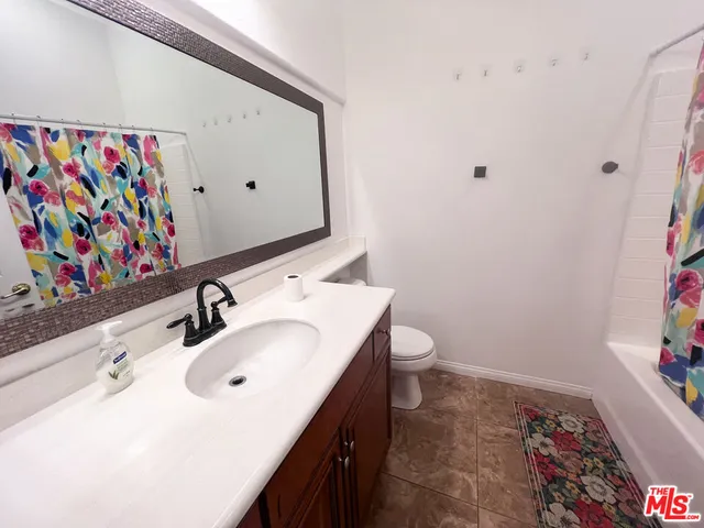 a bathroom with a sink mirror and vanity