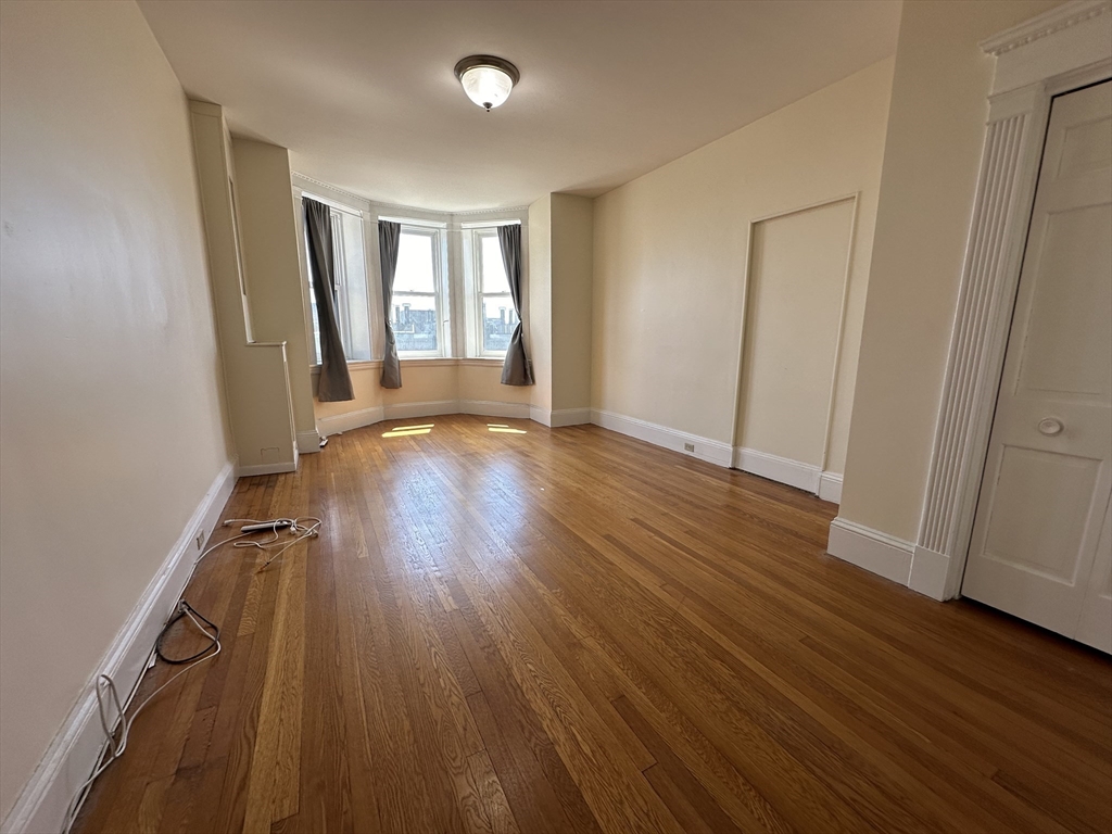 8 Garrison Street, Unit 609 Boston, MA 02116 - Photo 1 of 6 an empty room with wooden floor and windows