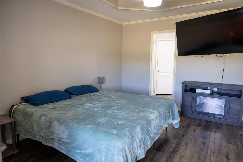 4773 Patton Lake Road Aquilla, TX 76622 - Photo 12 of 25 a bedroom with a bed and a flat screen tv