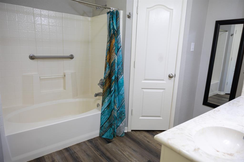 4773 Patton Lake Road Aquilla, TX 76622 - Photo 13 of 25 a bathroom with a tub and shower curtain