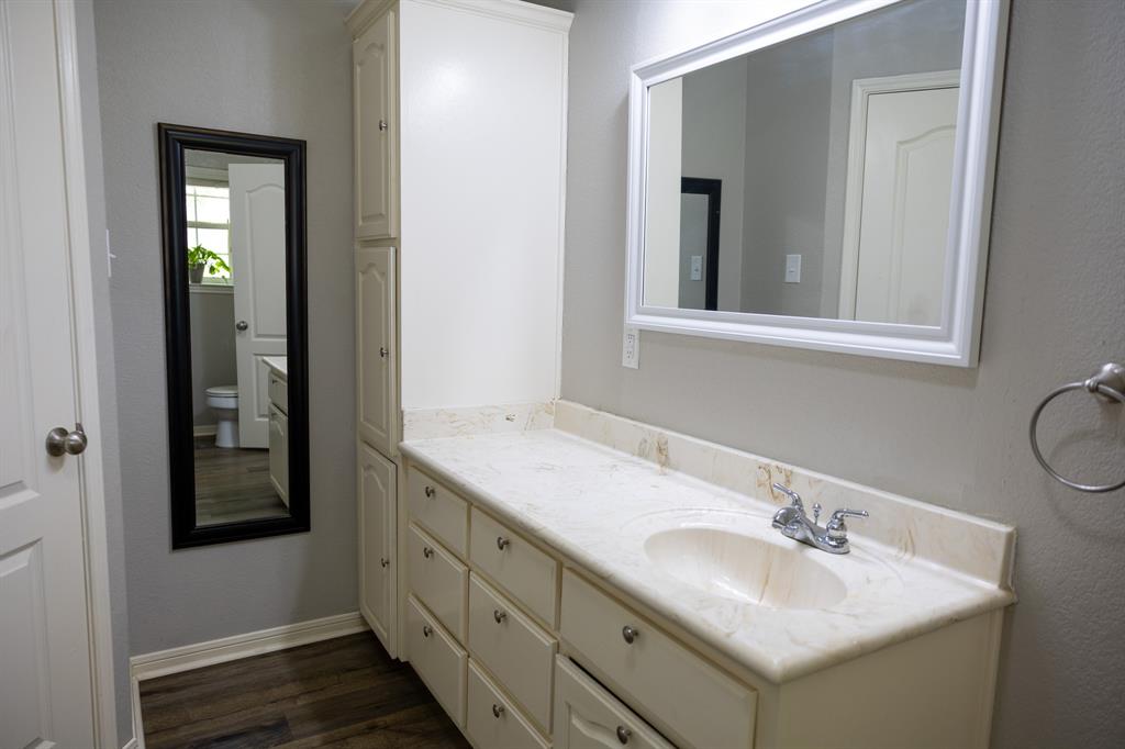 4773 Patton Lake Road Aquilla, TX 76622 - Photo 14 of 25 a bathroom with 2 sink and a mirror