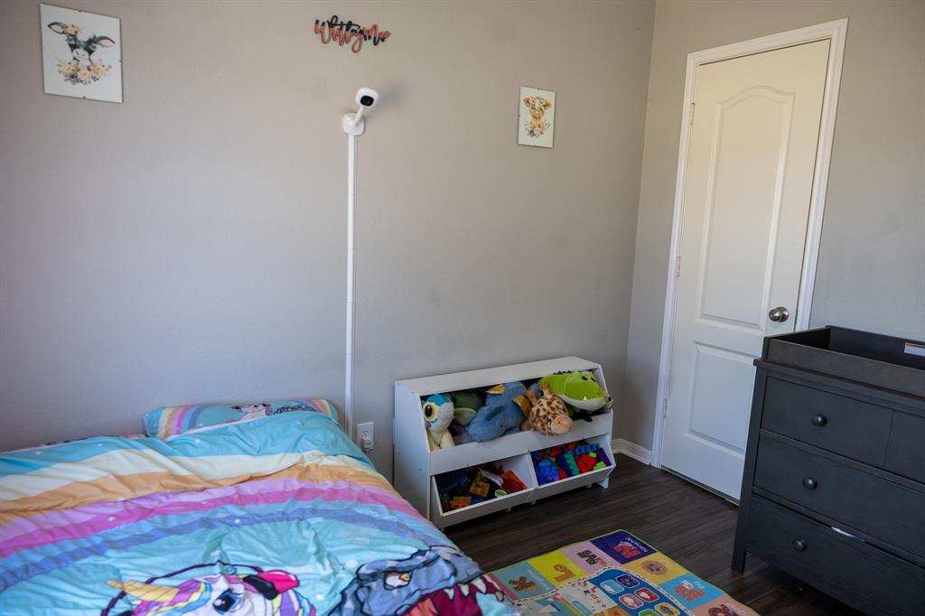 4773 Patton Lake Road Aquilla, TX 76622 - Photo 16 of 25 a bedroom with baby bed and closet