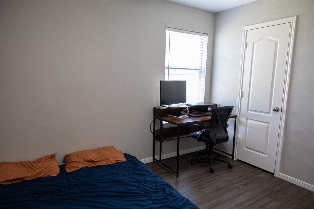4773 Patton Lake Road Aquilla, TX 76622 - Photo 19 of 25 a view of a workspace with wooden floor and a window