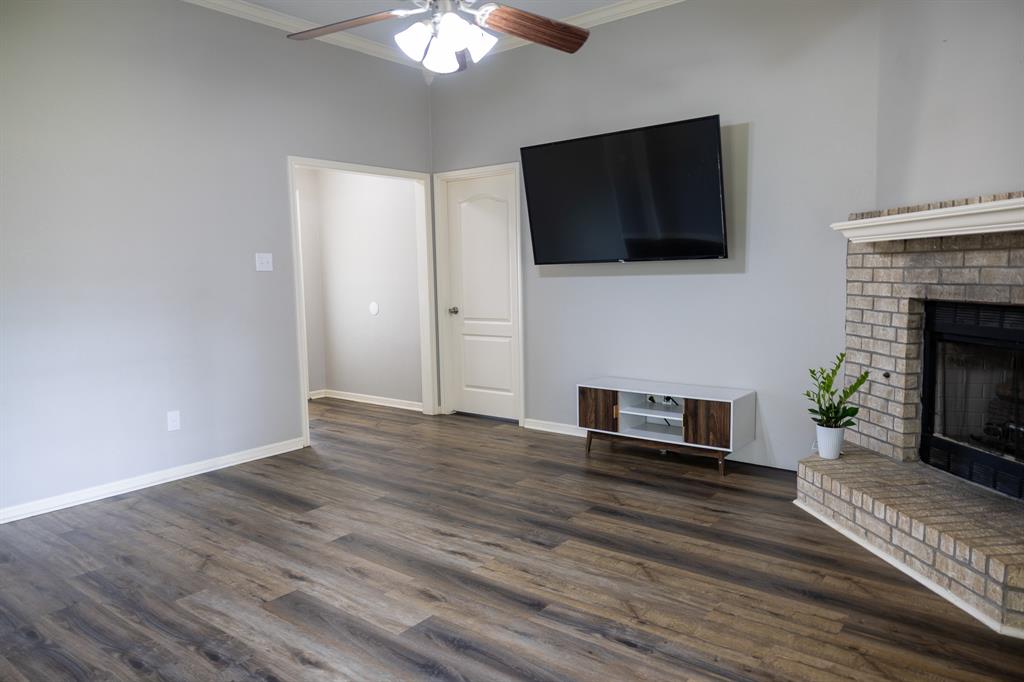 4773 Patton Lake Road Aquilla, TX 76622 - Photo 6 of 25 a living room with furniture a flat screen tv and a fireplace