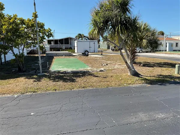 a view of a yard with car parked