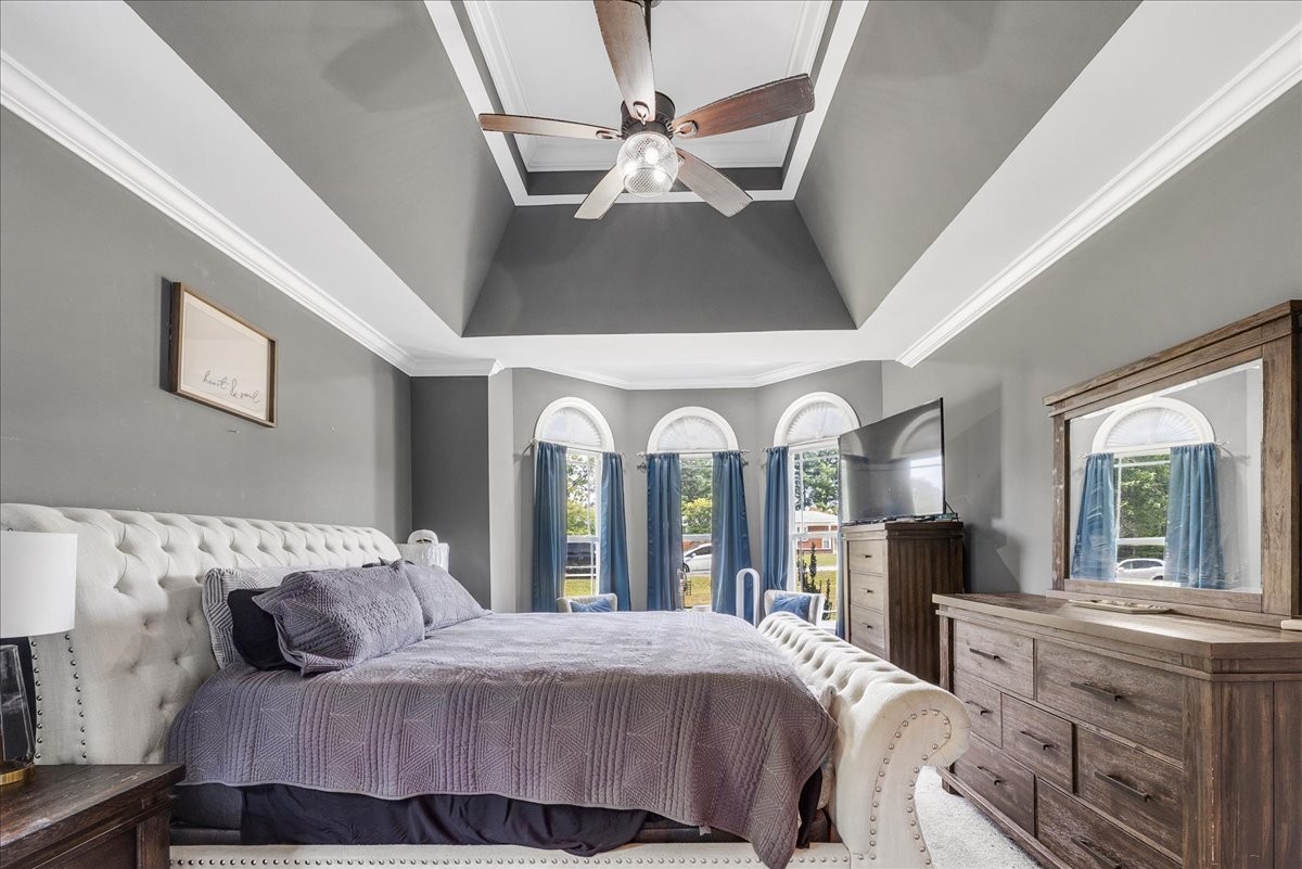 240 Taylor Road Manchester, TN 37355 - Photo 18 of 39 a bedroom with a bed ceiling fan and a large mirror on the dresser