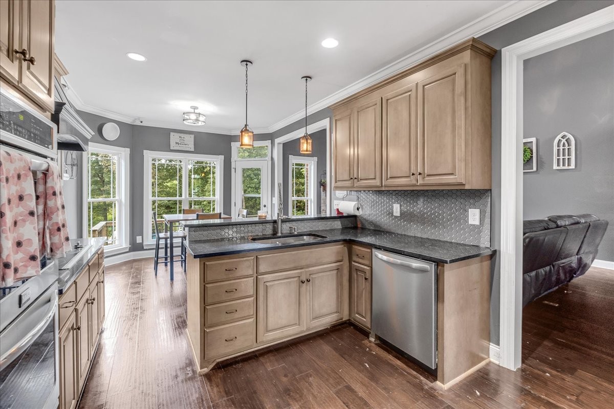 240 Taylor Road Manchester, TN 37355 - Photo 32 of 39 a kitchen with stainless steel appliances granite countertop a stove a sink and a refrigerator