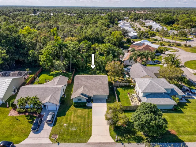 an aerial view of house with yard swimming pool and outdoor seating