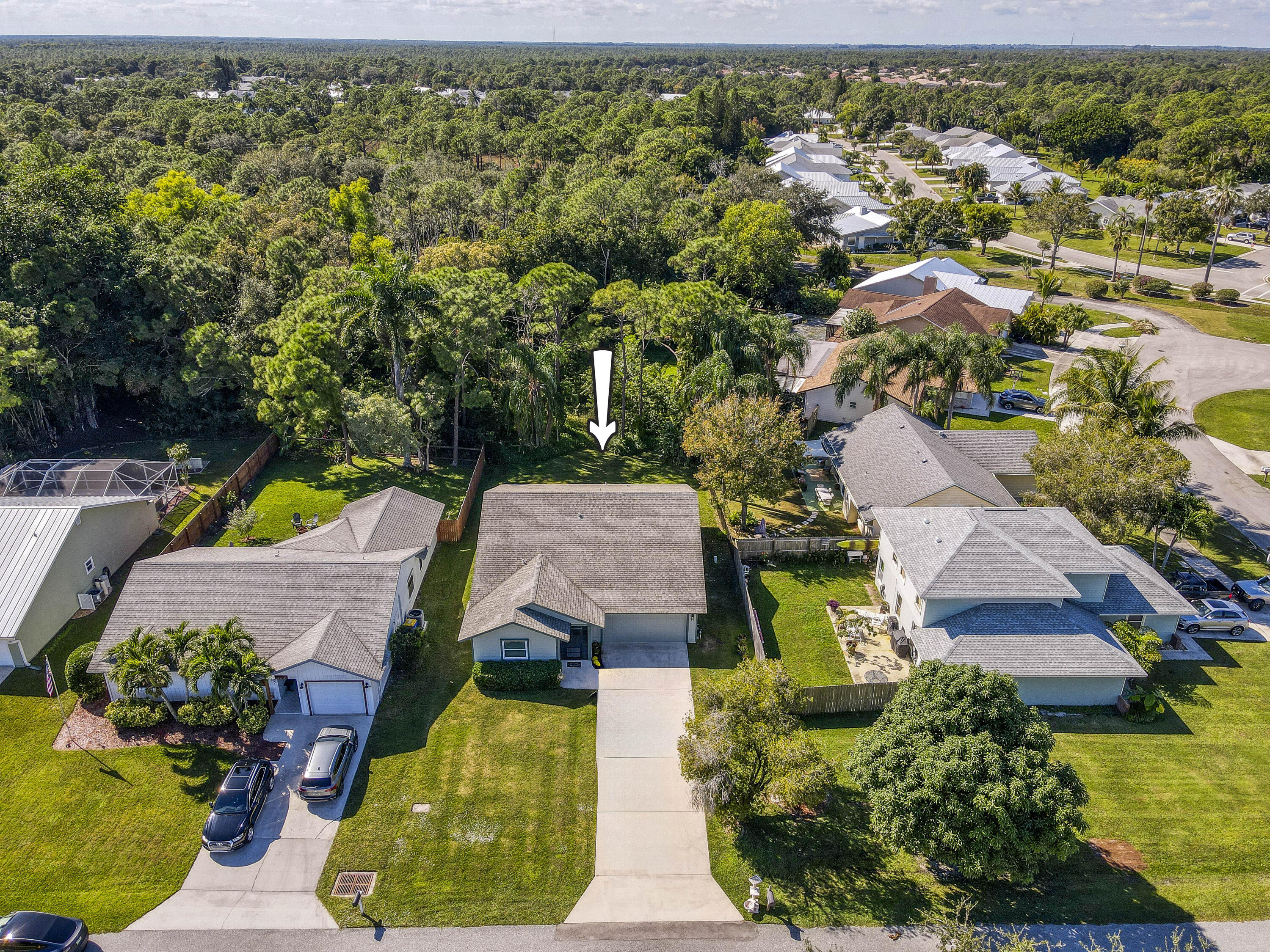an aerial view of house with yard swimming pool and outdoor seating
