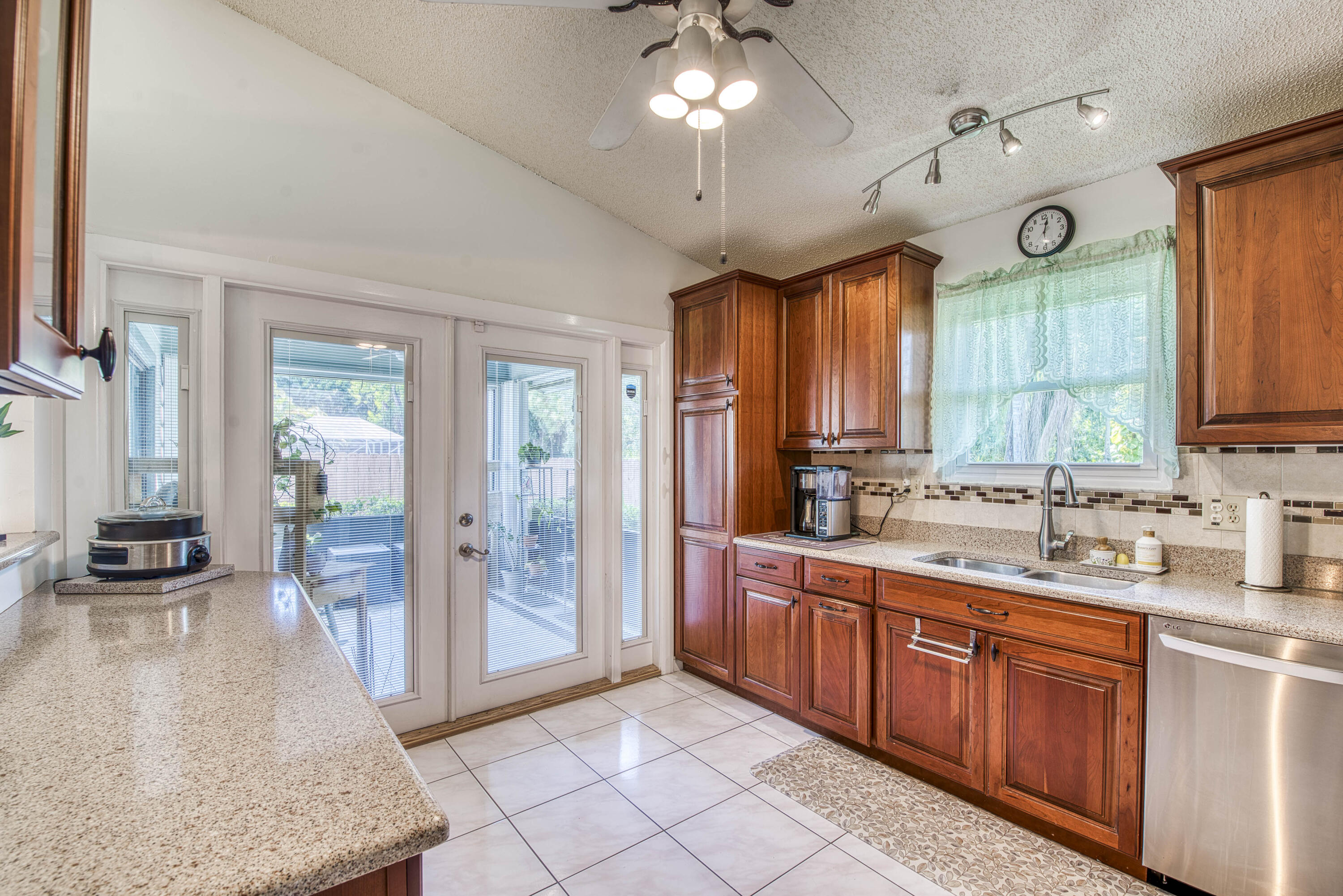 6690 Southeast Raintree Avenue Stuart, FL 34997 - Photo 13 of 43 a large kitchen with a large window and stainless steel appliances
